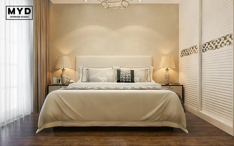 Beautifully styled bedroom with ornate lamps and headboard.